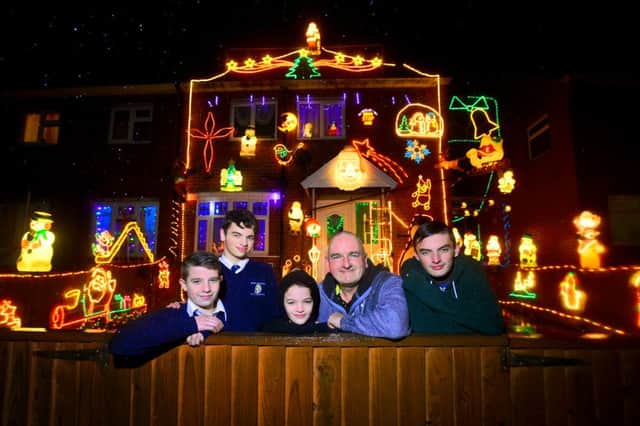 Andrew Watson has covered the outside of his house in Fieldhead with Christmas decorations. He is with his sons - Adam / Leam / Luke / Sam. (D542D451)