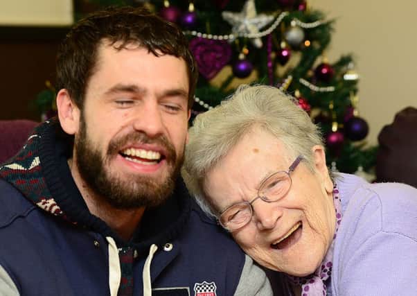 CHRISTMAS CHEER Emmerdale actor Kelvin Fletcher, who plays Andy Sugden, delivering presents to Ashworth Grange resident Mary Cafferty.