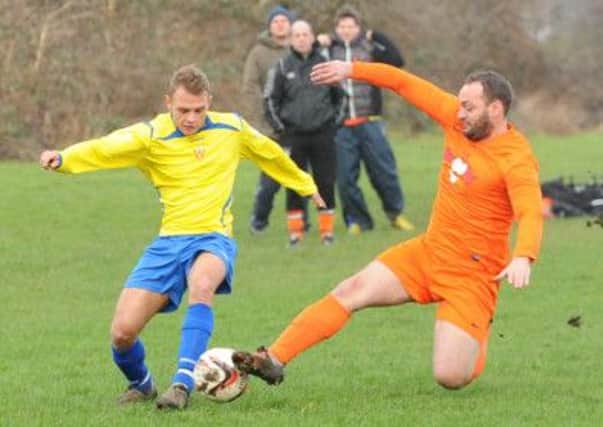 Will Clapham of Woodkirk Valley is tackled by Wayne Nock of Barr Street during the Heavy Woollen Sunday League clash. Picture: Steve Riding