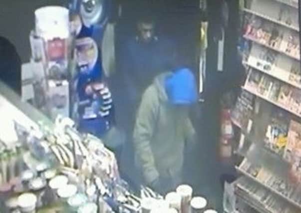 CCTV image of a robbery that took place at a newsagent in Bradford Road, Batley.