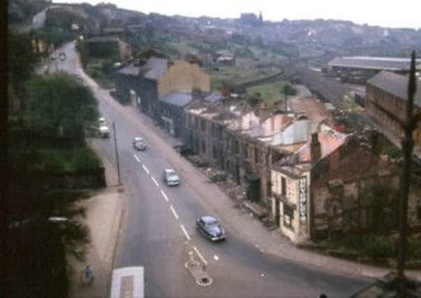 This is how the bottom end of Wakefield Road used to look before road widening in 1960/1. The photograph was probably taken from a window in Dewsbury Town Hall just below.. In the foreground on the bottom right (where the Beverley sign can be seen) is the Forrester's Arms public house, and just behind are the storage buildings of the old Lancashire and Yorkshire Railway. In the background can be seen the spire of St Peter's Church, Earlsheaton, now demolished. The photographs are part of a collection taken by the old Dewsbury Borough Engineer's Department.