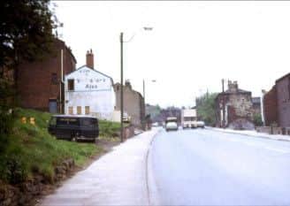Further up Wakefield Road, on the left-hand side can be seen the Globe Inn, another Dewsbury pub lost to Dewsbury in road widening schemes. Just in front is a black police van, and further up was a grocer's shop, also demolished.
