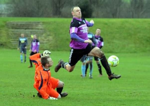 Thornhills Scott Hargeaves takes on Swillington goalkeeper James Marston in last Saturdays West Yorkshire League Division One clash.