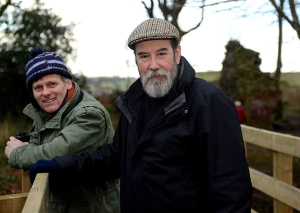 Tim Duke and community archaeologist Kev Cale on the timber bridge.