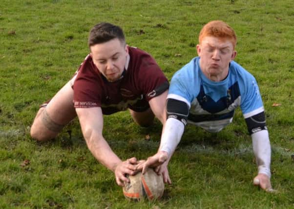 Thomas Ripley just gets to the ball ahead of a Heysham defender to score during Thornhill Trojans convincing BARLA National Cup victory last Saturday.
