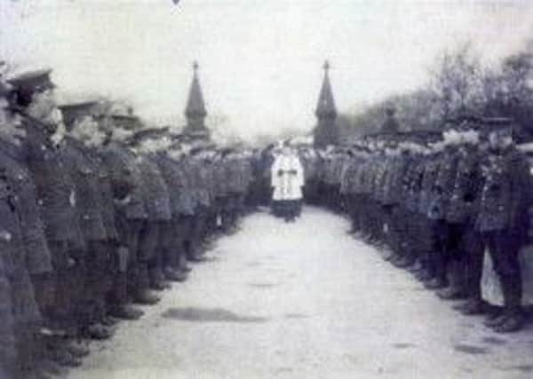 Soldiers from the Kings Own Yorkshire Light Infantry form a sombre guard of honour outside Dewsbury Cemetery for the burial of their comrade, Private John Myers, who was tragically killed in February 1915. The Reverend F.J.Martin (pictured), curate-in-charge of St Mary's Church, Savile Town, conducted the funeral service.
