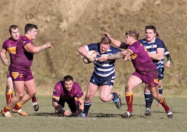 The scrambling Dewsbury Moor defence attempt to get to grips with a Sharlston attacker during Saturdays cracking National Cup tie at Heckmondwike Road.