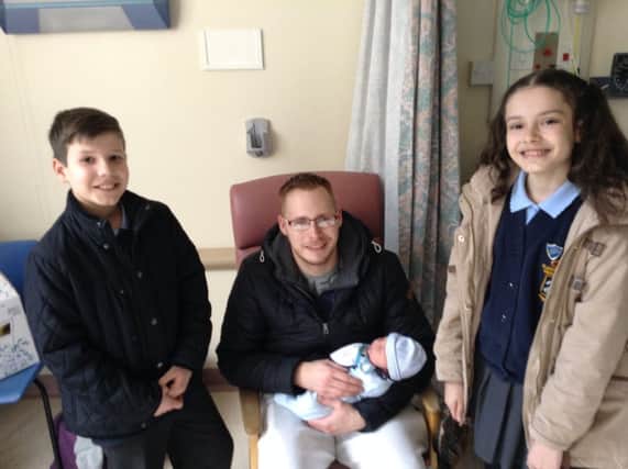 St Joseph's pupils Millie Clapham and Zenon Brzoza, pictured with dad Nik Mason and baby Thomas.