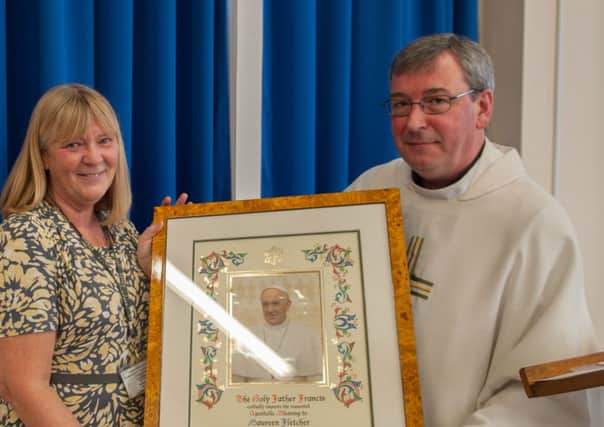 Maureen Fletcher was presented with a plaque by Paul Fisher.