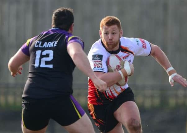 Dewsbury prop Byron Smith attempts to set up an attack, running at Newcastles Ryhys Clarke.