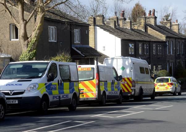 Police close to the scene where human remains were found in Scholes Lane, Cleckheaton.