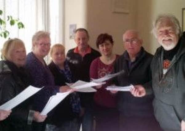 Friends of Heckmondwike Library hand their petition to Kirklees Council leader David Sheard.