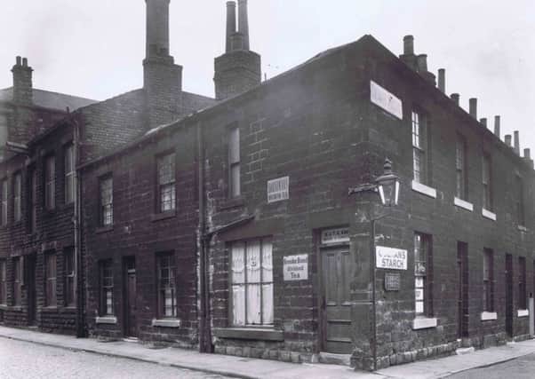 This picture taken at the bottom of Victoria Road, Springfield, Dewsbury, probably in the 1920s or 30s,is an important piece of social history. It shows the kind of houses built during the Industrial Revolution. The houses were demolished in the mid 1950s during the town's massive slum clearance programme.