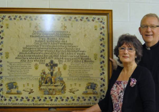 Margaret Watson and the Rev Canon Kevin Partington with the tapestry at Dewsbury Minster.