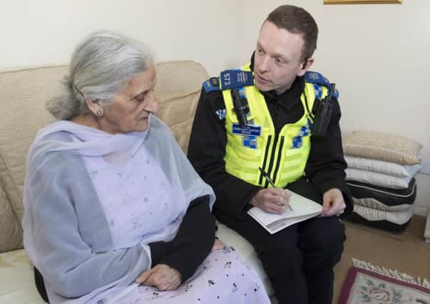 PCSO Gareth Price from the Wakefield Neighbourhood Policing Team with resident Hardeep Kaur Kalsi whose husband has dementia.