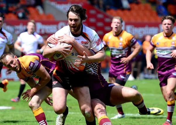 Scott Hale charges through the Batley defence to score Dewsburys first try at the Summer Bash in Blackpool.