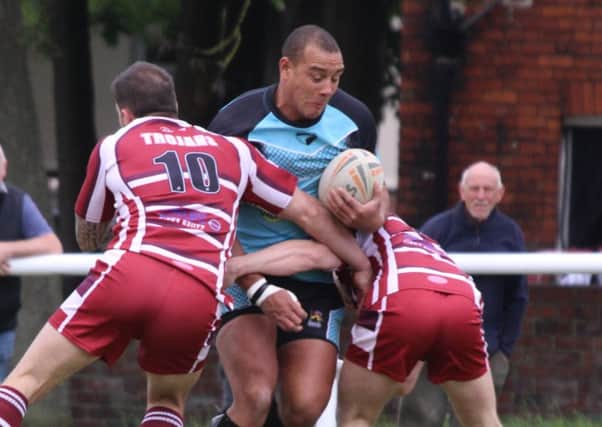 The Trojans defence get to grips with Hunslets Caldon Bravo during Saturdays National Conference Trophy clash.