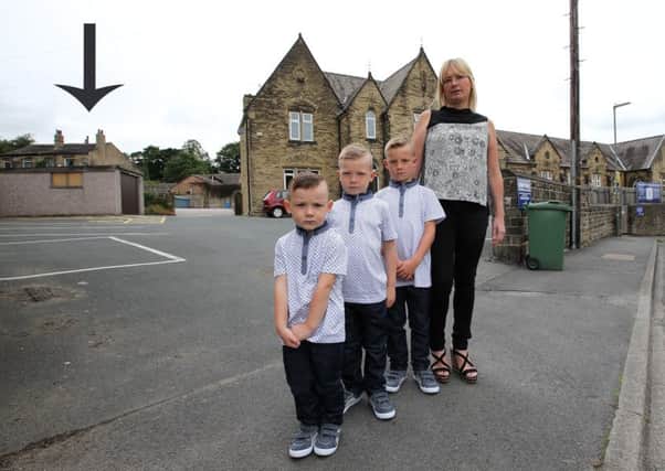 Claire Fletcher with her children Joshua, Jacob and Samuel outside Norristhorpe Junior and Infant School, where her older boys attend, but Joshua, 4, can't - even though they live next door.