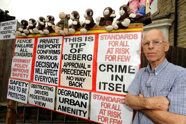 Gary Flowers has mounted an expensive campaign to get a neighbours tall fence removed.