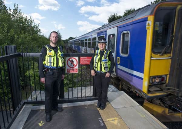 British Transport Police's Carl Hall and Sgt Jacqui Wilson at Mirfield station, raising awareness of the danger of trespassing on train lines.