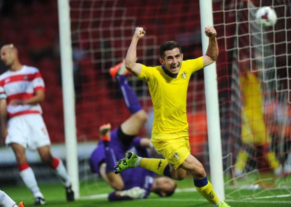 Lewis Cook celebrates his first goal for Leeds United at Doncaster before getting sent-off.