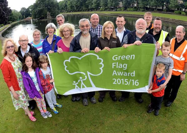Friends of Wilton Park group with park grounds staff and the flag.