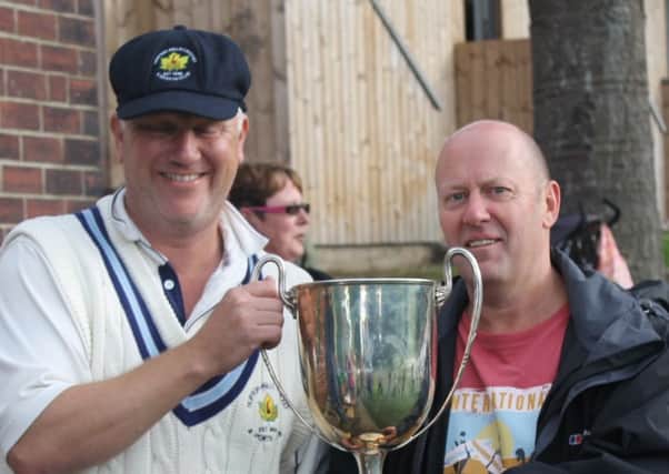 Hopton Mills captain Richard Myers receives the Championship trophy from CYL chairman Mark Heald following a dramatic end to the season.