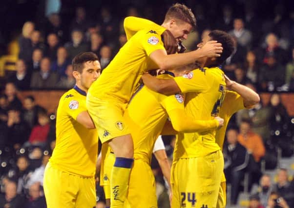 Leeds United players celebrate after Chris Wood scores from the penalty spot against Fulham. Picture: Tony Johnson