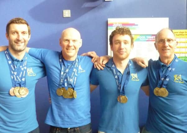 Chris Knee, Paul Clemence, James Warren and Bill Moore show off their National Masters Swimming Championships medals