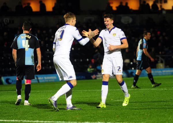 Sam Byram celebrates his goal at Wycombe with fellow goal scorer Lee Erwin. Picture: Jonathan Gawthorpe