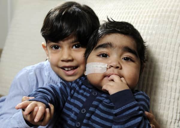 One-year-old Dawud Raza and his life-saving sister, Khadijah, three.