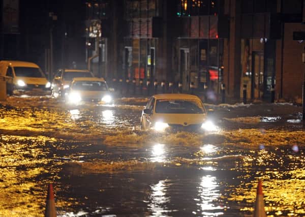 Cars drive through floodwater after the River Aire burst its banks.  Picture Tony Johnson