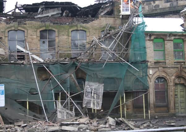 Demolition teams at work on Stanbury Buildings in Bradford Road, which collapsed on Saturday January 16. Picture: Phil Rushworth.