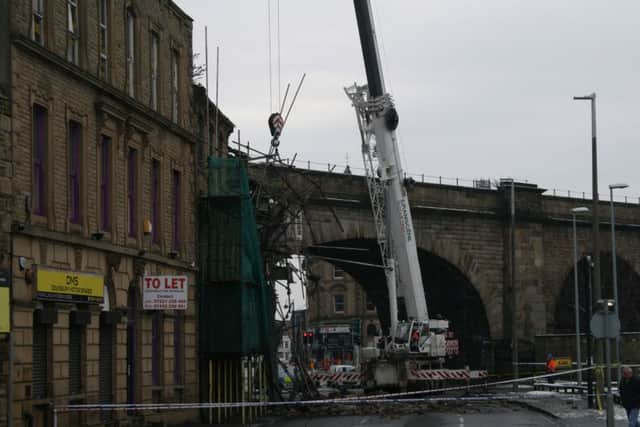 Demolition teams at work on Stanbury Buildings in Bradford Road, which collapsed on Saturday January 16. Picture: Phil Rushworth.