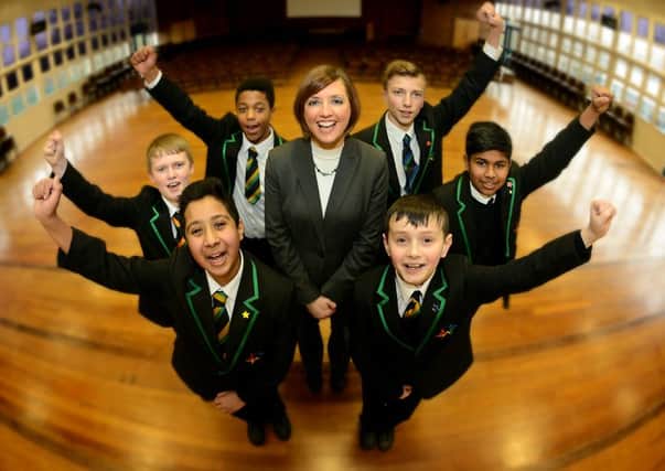 Upper Batley High School has made a dramatic turn round which has seen them come out of a 'Needs Improvement' to 'Good' rating.
Pictured: Head teacher Miss Sam Vickers celebrates with pupils. (AB016a0116)