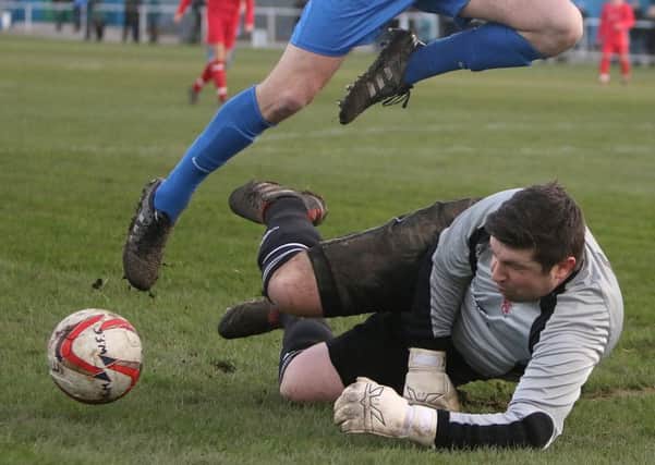 Liversedge goalkeeper Dominic Smith makes a brave save in the recent game against Staveley MW.
