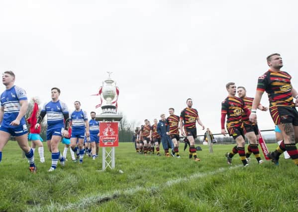 Shaw Cross Sharks and Lock Lane enter the field past the Challenge Cup.