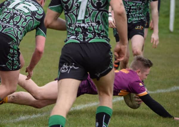 Archie Bruce dives over for a try for Dewsbury Moor Under-18s.