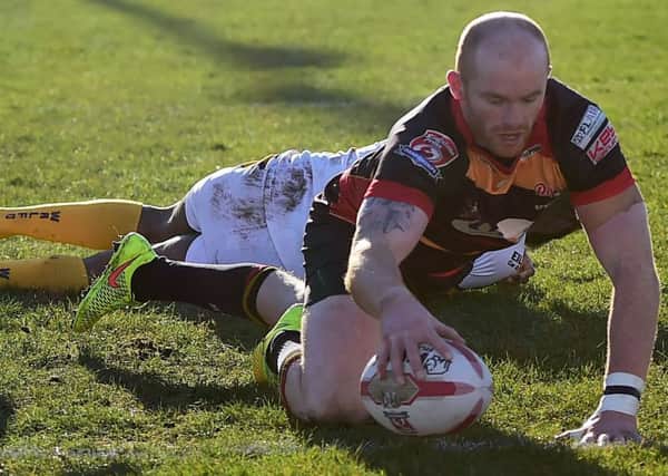 Shane Grady evades the clutches of a Whitehaven defender to score a Rams try. Pictures: Paul Butterfield