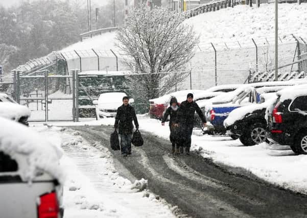 Passengers make their way through the snow to Leeds Bradford Airport. PIC: PA