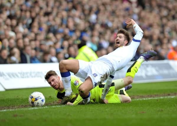 Leeds United's Luke Murphy is fouled by Huddersfield Town's James Husband.  Picture Tony Johnson