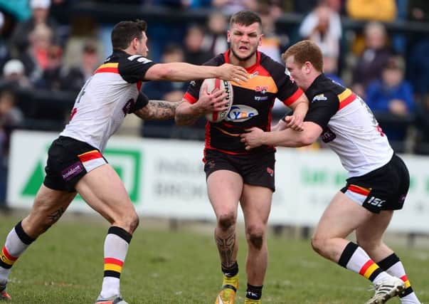 Dewsbury's Kyle Trout attempts to break through Bradford defenders Ross Oakes and Jay Pitts.