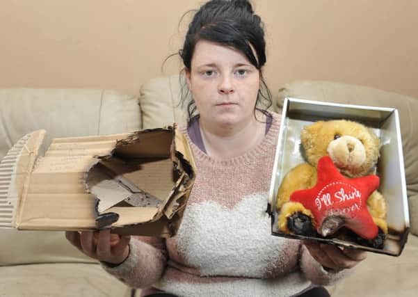 Shaunnah Manners with the burnt teddy bear bought in memory of her baby son.