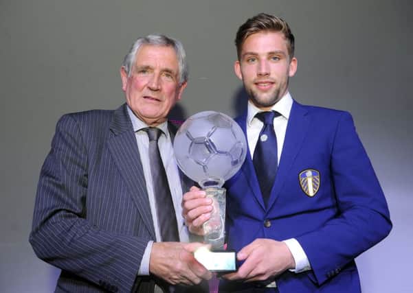 Charlie Taylor receives the Leeds United player of the year trophy from Norman Hunter.