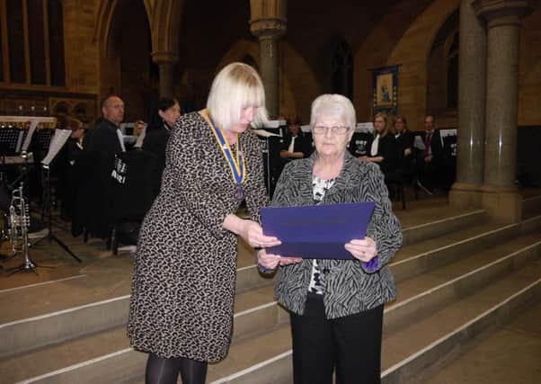 Mirfield Rotary Club president Sue Charlesworth presents Cath Knowles with her award for her work with dementia sufferers.