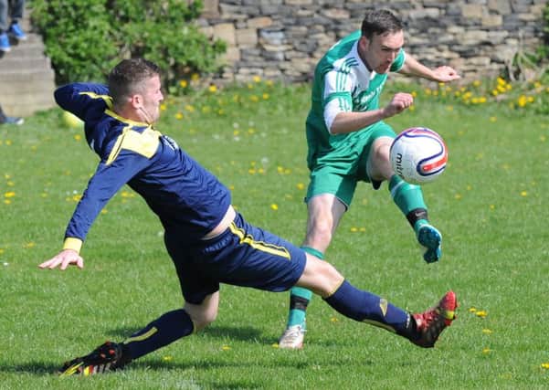 Dominic Simpson  of  St John Fisher shoots past  Woodman defender  Joe Rhodes on the way to clinching his sides Premier Division title last Sunday. Picture: Steve Riding.