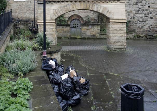 Rubbish strewn around the base of the Batley Bats monument.