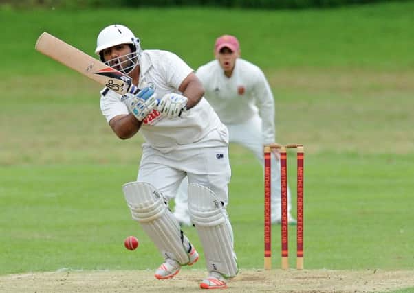 Arsham Malik of Gomersal goes on the attack before rain stopped play against Methley.