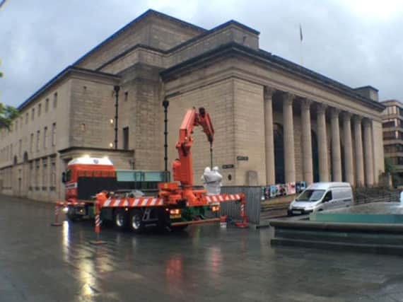 Women Of Steel statue is craned in to position in Barker's Pool, outside Sheffield City Hall.