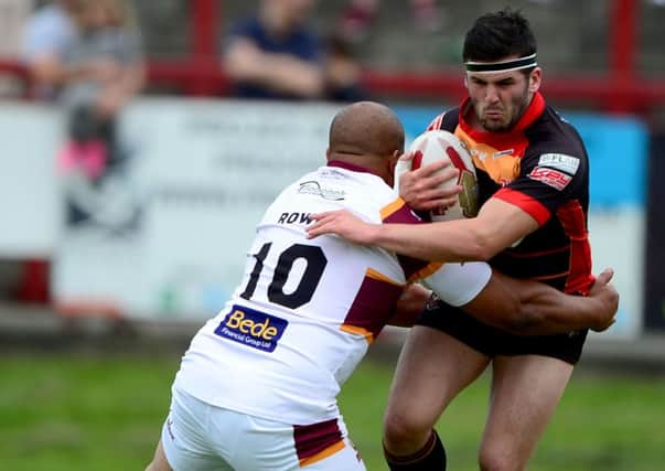 Nathan Conroy attempts to beat Batley prop Alex Rowe during last Sundays derby. Pictures: Paul Butterfield